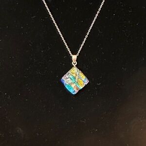 Dichroic Square Glass Charm Silver pendant necklace. Pendant is set triangular